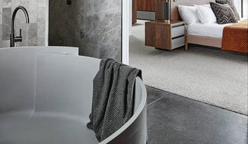 A large grey stone bathroom and bath