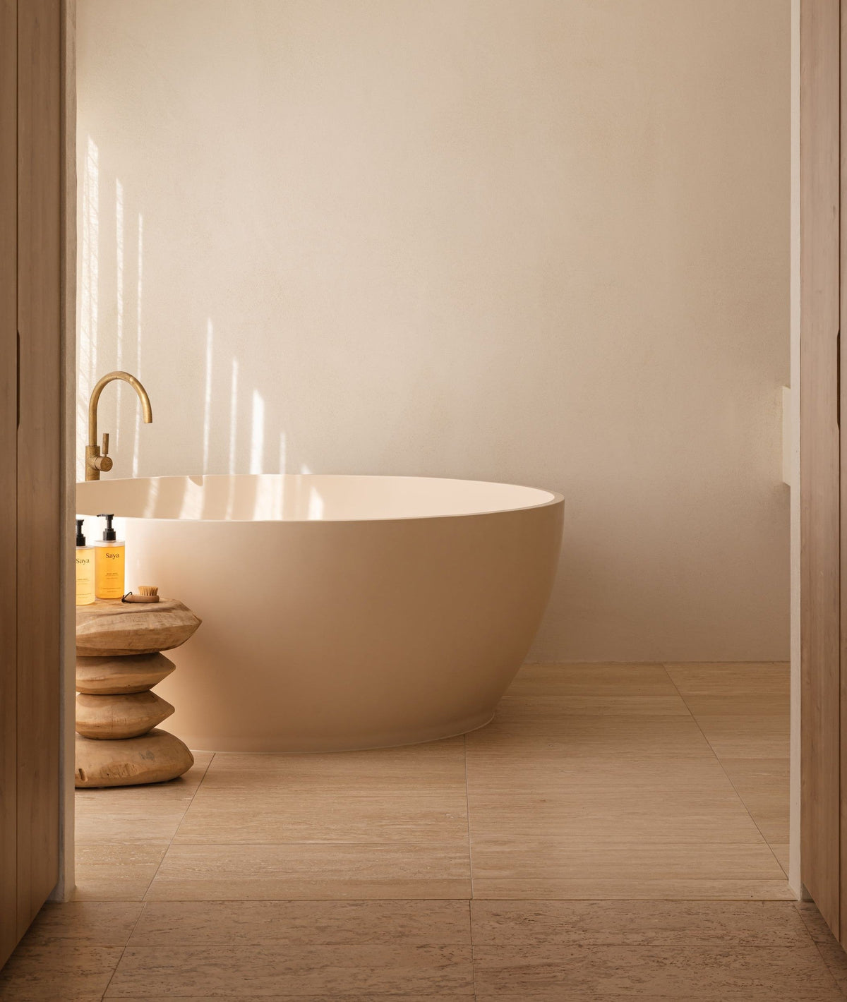 A grey outdoor bath in palm tree garden