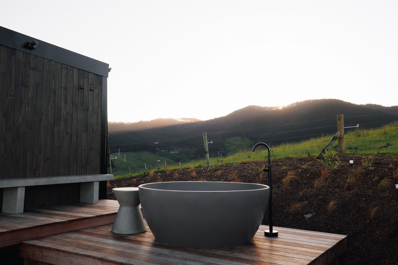 grey outdoor round bath on a deck at air bnb